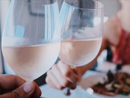 two person toasting wine glass cups