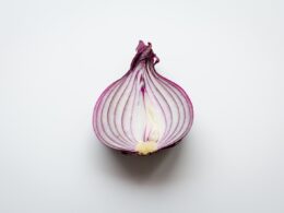 pink and white garlic on white surface