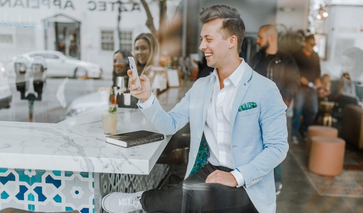 smiling man while holding smartphone