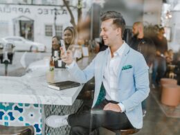 smiling man while holding smartphone