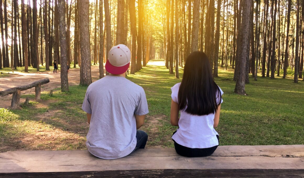 Man and Woman Sitting on Bench in Woods