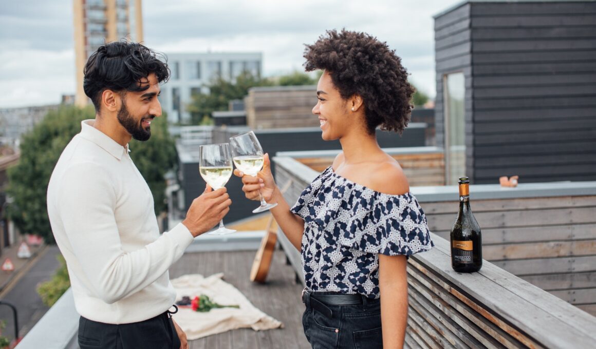 A Couple Toasting their Glasses with White Wine