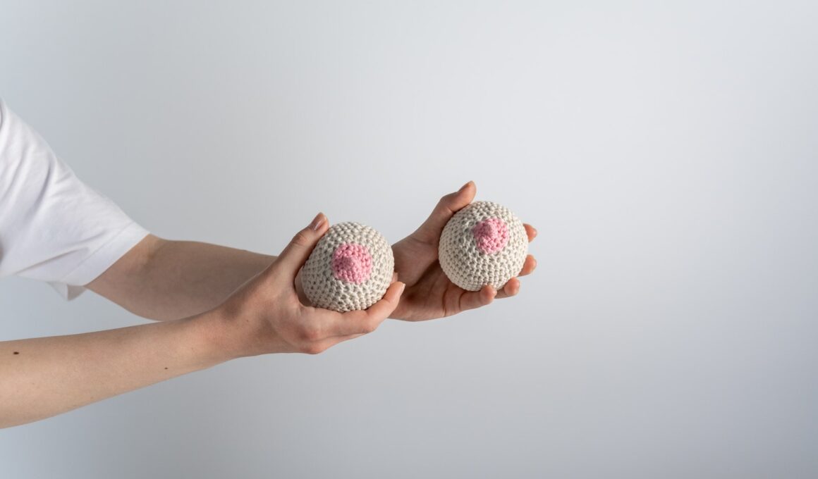 A Person Holding Beige and Pink Knitted Breast