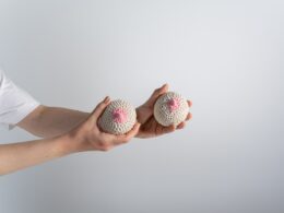 A Person Holding Beige and Pink Knitted Breast