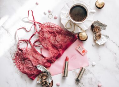 Red Brassiere Beside Black Coffee on Marble Surface