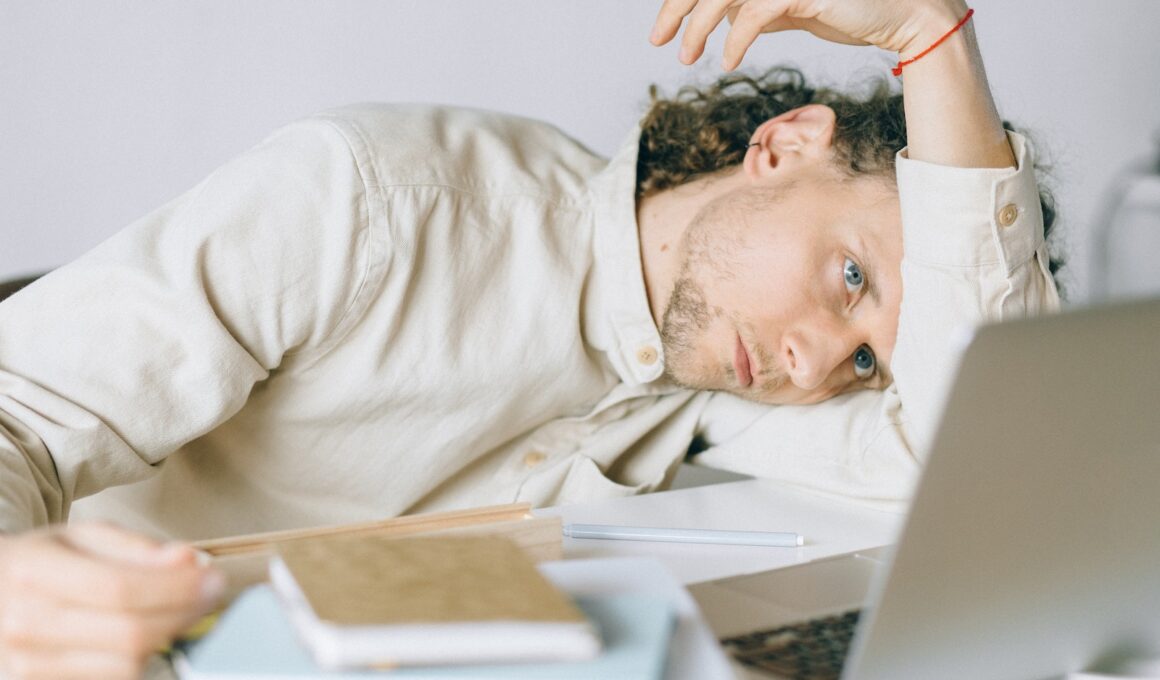 Overworked Employee lying in front of Laptop