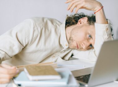 Overworked Employee lying in front of Laptop
