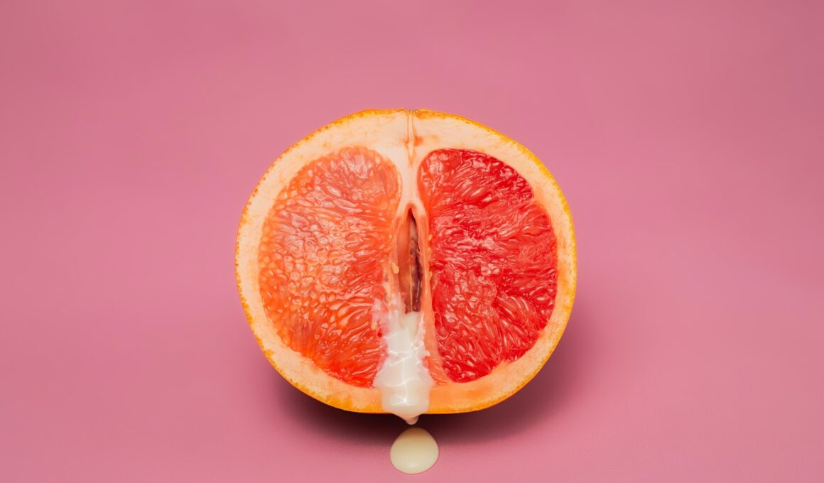 Sexy grapefruit with sperm against pink background