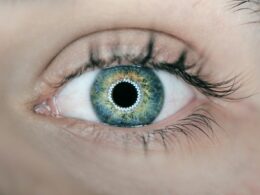 person showing green and black eyelid closeup photography