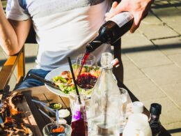 man sitting while pouring wine