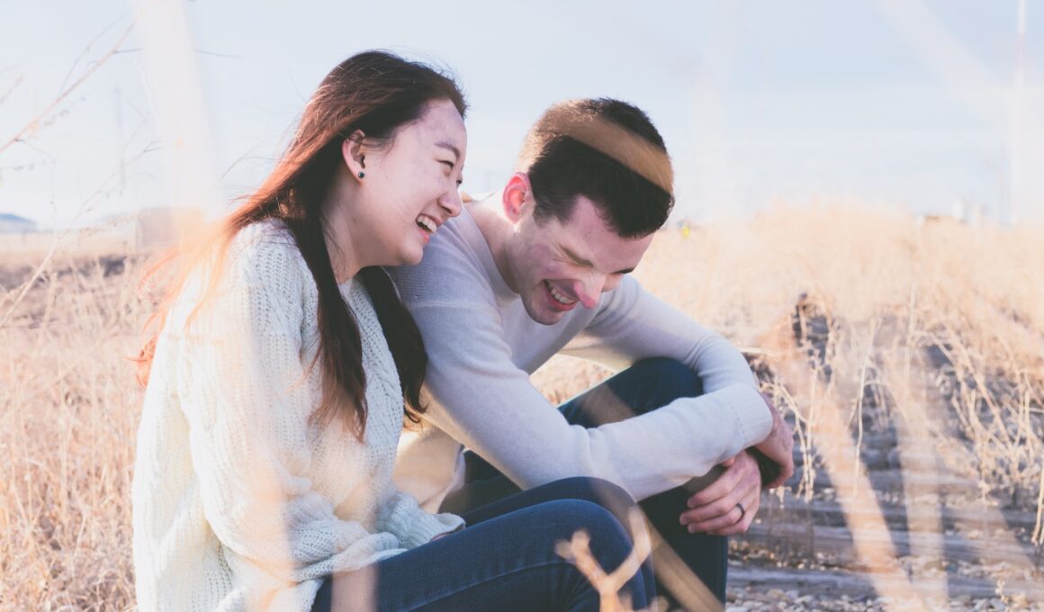 photo of man and woman laughing during daytime