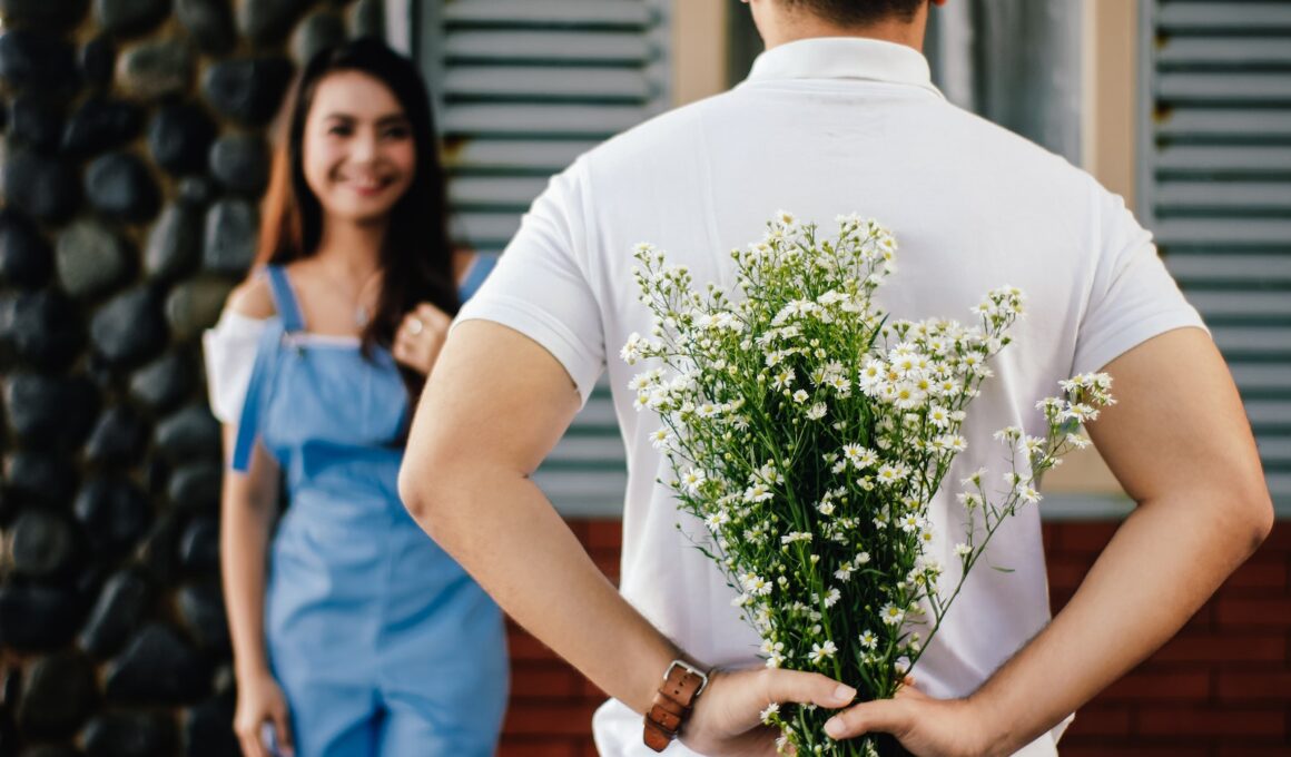 Man Holding Baby's-breath Flower in Front of Woman Standing Near Marble Wall