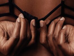 person holding black brassiere strap