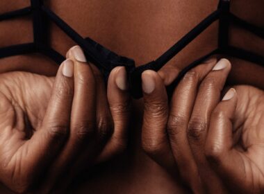 person holding black brassiere strap