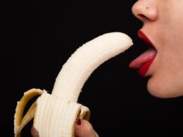 person holding banana with tongue out