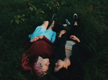 two women lying on grasses