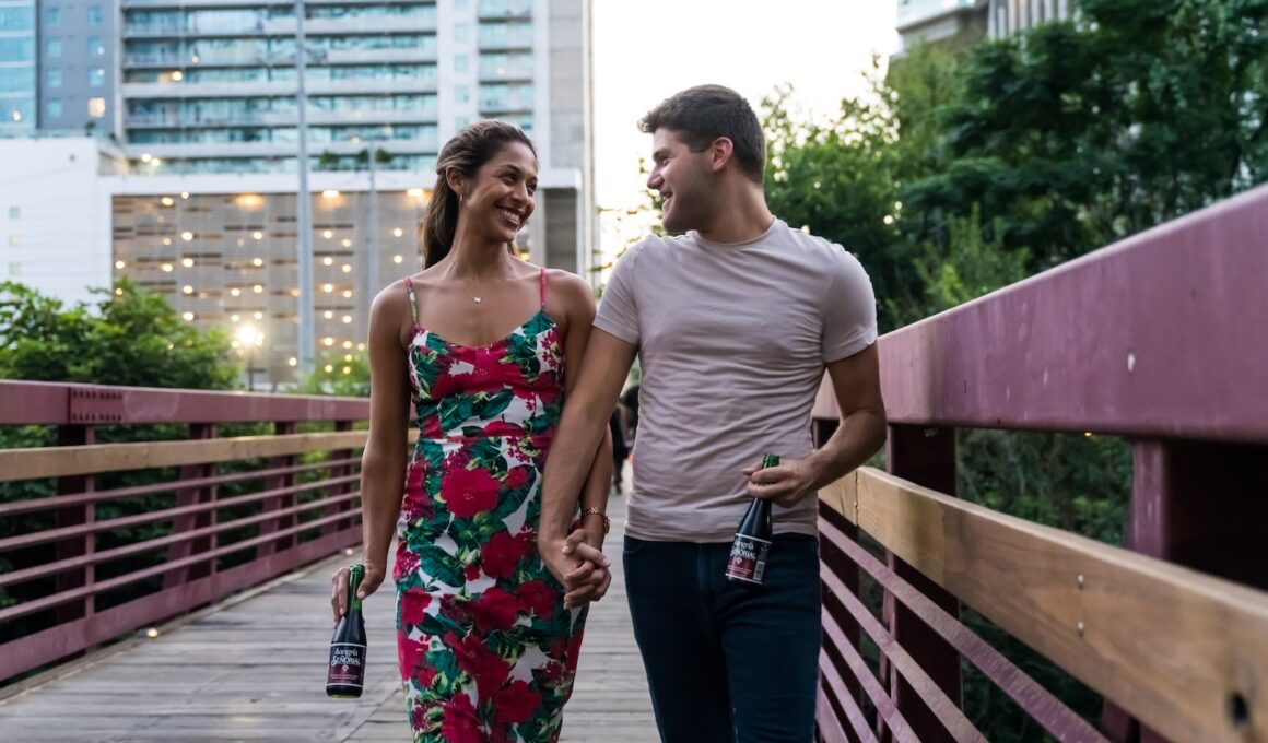 man and woman standing on wooden bridge during daytime