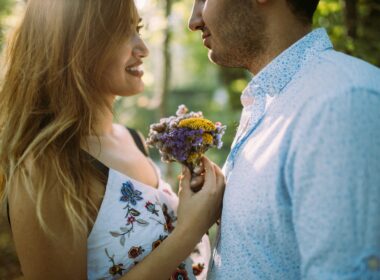 man and woman facing each other while holding flowers