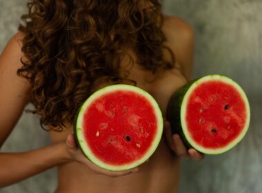 person holding sliced watermelon fruit