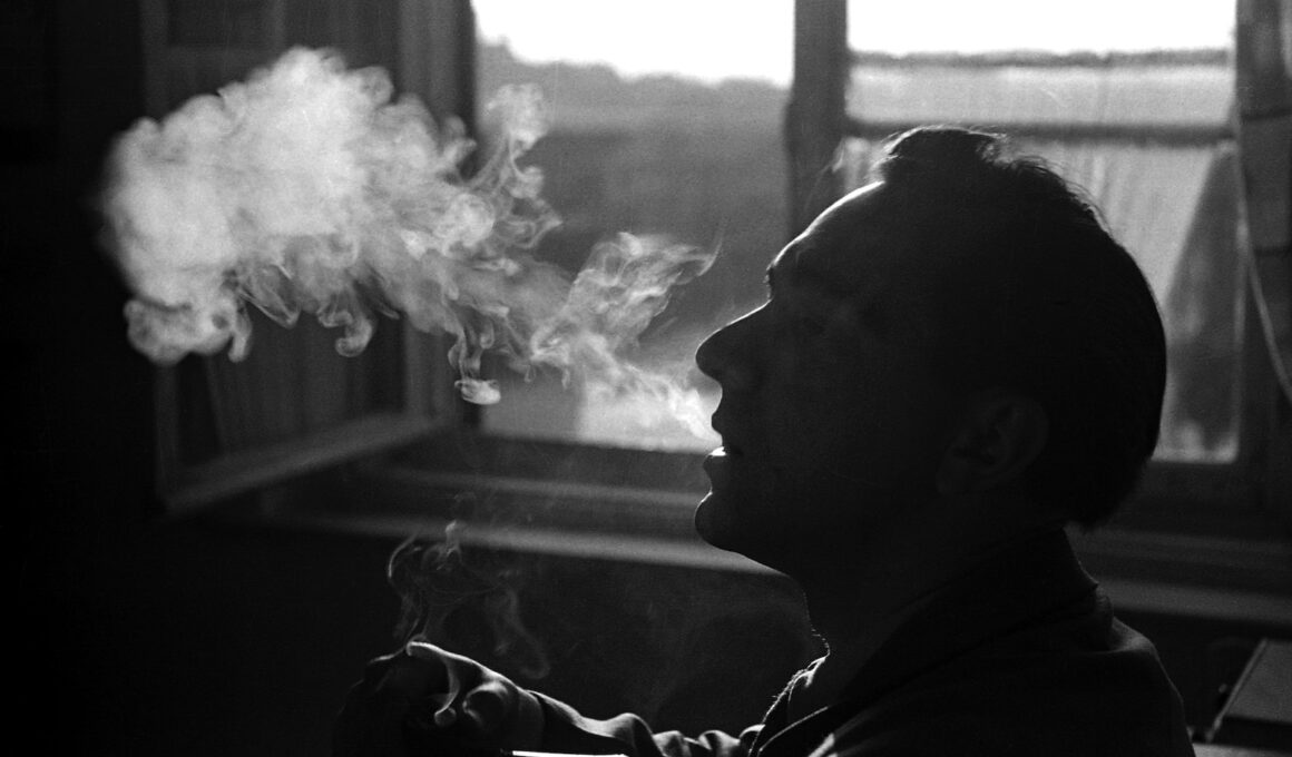 person smoking beside window