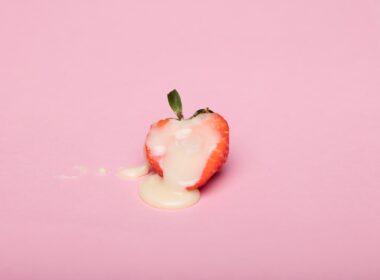 red cherry fruit on pink surface