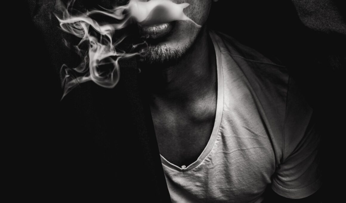 man wearing white V-neck shirt with smoke coming out of mouth