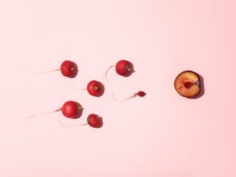 red cherry fruits on white surface