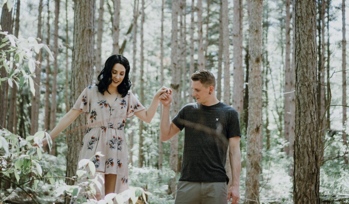 man holding hands with woman near trees